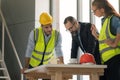 Team of multiethnic architects working on construction plans in meeting room. Engineers discussing on project in office Royalty Free Stock Photo