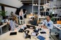 Team of multiethnic diverse colleagues in the office meet their disabled friend on wheelchair. Pretty blond girl rolls Royalty Free Stock Photo