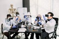 Team of multiethnic doctors, chemists, scientists in modern research laboratory using virtual reality goggles, gesturing Royalty Free Stock Photo