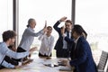 Team of multiethnic employees giving high five at group meeting Royalty Free Stock Photo