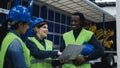 Team of multiracial engineers working in robotic factory monitoring the project on laptop Royalty Free Stock Photo