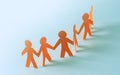 Team of paper doll people holding hands Royalty Free Stock Photo