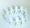 Team of paper doll people holding hands Royalty Free Stock Photo