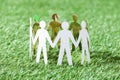 Team of paper people on grassy field Royalty Free Stock Photo