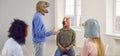 Team of people wearing funny crazy animal masks talking during their meeting in the office