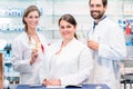 Team of pharmacists in drug store checking pharmaceuticals Royalty Free Stock Photo