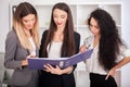 Team portrait of happy businesswomen standing on office corridor Royalty Free Stock Photo