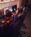 A team of professional cyber sportmans, trains for the championship, plays in a multiplayer video game on pc in a gaming Royalty Free Stock Photo