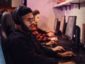 A team of professional cyber sportmans, trains for the championship, plays in a multiplayer video game on pc in a gaming Royalty Free Stock Photo