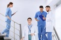 Team of professional doctors on staircase
