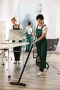 Team of professional janitors working in office. Cleaning service