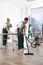 Team of professional janitors working in modern office. Royalty Free Stock Photo