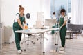 Team of professional janitors working in modern office