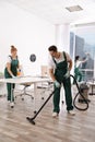 Team of professional janitors working in office. Cleaning service