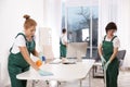 Team of professional janitors working in office. Cleaning Royalty Free Stock Photo