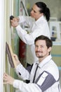 team professional painters with tools working indoors Royalty Free Stock Photo