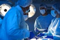 Team of professional surgeons performing operation