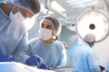 Team of professional surgeons performing operation