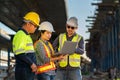 A team of professionals, civil engineers, architects are inspecting the expressway construction project site. With data on laptop Royalty Free Stock Photo