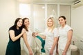 A team of professionals in a dental clinic, posing near the equipment