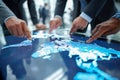 Team of professionals using a futuristic interactive digital map display for strategic planning and global business collaboration Royalty Free Stock Photo