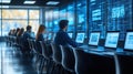Team of IT professionals working in a large server room, focusing on displays showing data and complex algorithms Royalty Free Stock Photo