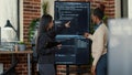 Team of programmers analyzing code on wall screen tv looking for bugs and errors Royalty Free Stock Photo