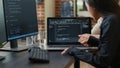 Team of programmers talking about algorithm running on laptop screen pointing at source code Royalty Free Stock Photo