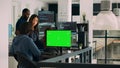 Team of programmers working on source code with greenscreen monitor Royalty Free Stock Photo