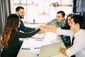 Team put hands together, show connection and alliance, top view of working table. Teambuilding in office, young businessmen and wo Royalty Free Stock Photo