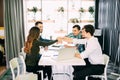 Team put hands together, show connection and alliance, top view of working table. Teambuilding in office, young businessmen and wo Royalty Free Stock Photo