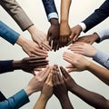A team putting their hands in the middle, symbolising diversity of culture and ethnicity Royalty Free Stock Photo