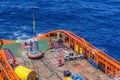 A team of riggers or roughnecks landing a personal transfer basket on anchor handling tug boat