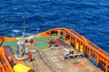 A team of riggers or roughnecks landing a personal transfer basket on anchor handling tug boat Royalty Free Stock Photo