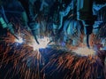 Team robots are welding part in automotive industrial factory