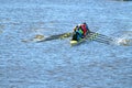 A team of rowers in a sports boat.