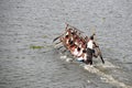 Team Rowers in Traditional Boat Working Together on a Calm Lake Surface Royalty Free Stock Photo