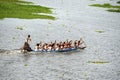 Team Rowers in Traditional Boat Working Together on a Calm Lake Surface Royalty Free Stock Photo