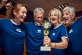 Team senior soccerball players excited about winning gold cup Royalty Free Stock Photo