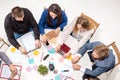 Team sitting behind desk, checking reports, talking. Top View Royalty Free Stock Photo