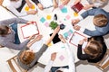 Team sitting behind desk, checking reports, talking. Top View Royalty Free Stock Photo