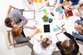 Team sitting behind desk, checking reports, talking. Top View Royalty Free Stock Photo