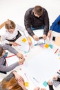 Team sitting behind desk, checking reports, talking. Top View Royalty Free Stock Photo