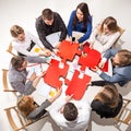 Team sitting behind desk, checking reports, talking. Top View Royalty Free Stock Photo