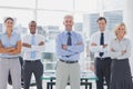 Team of smiling business people standing with arms folded Royalty Free Stock Photo