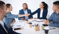 Team of smiling diverse business people shaking hands in office after meeting in boardroom. Group of happy professionals Royalty Free Stock Photo