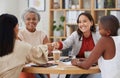 Team of smiling diverse business women shaking hands in office after meeting in boardroom. Group of happy professionals Royalty Free Stock Photo