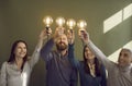 Team of happy people holding light bulbs as symbol of creative, innovative ideas