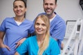 Team of smiling and satisfied dentists in dentist`s office