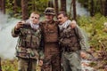 Team of soldiers and terrorist taking selfie with smartphone in the forest